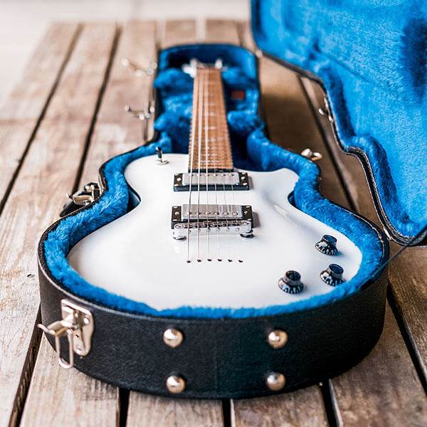 white electric guitar in black hardshell case with blue interior