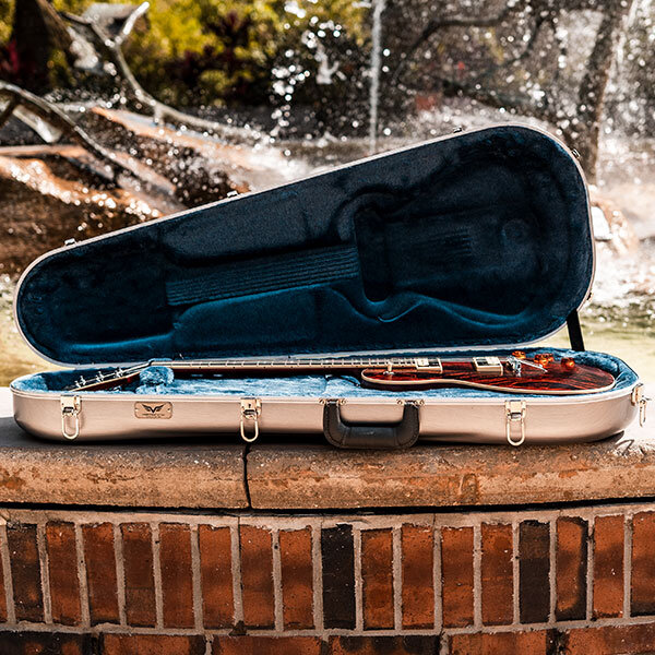 electric guitar in open molded guitar case on wall of fountain