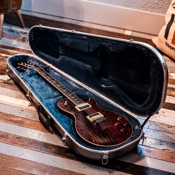 black electric guitar in open molded guitar case
